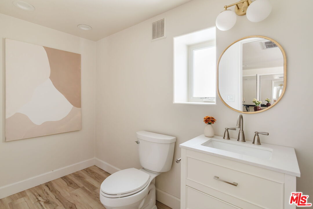 131 Galleon Street, Unit 2 Marina del Rey, CA 90292 - Photo 15 of 21 a bathroom with a toilet a sink a mirror and a window