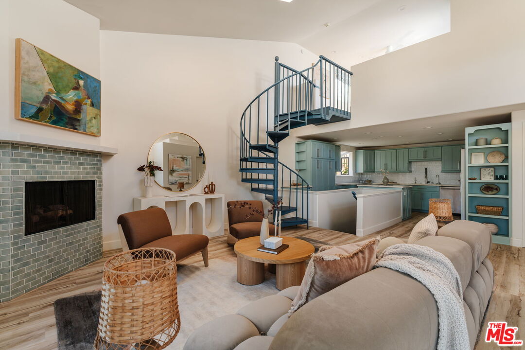 131 Galleon Street, Unit 2 Marina del Rey, CA 90292 - Photo 2 of 21 a living room with furniture a rug and a fireplace