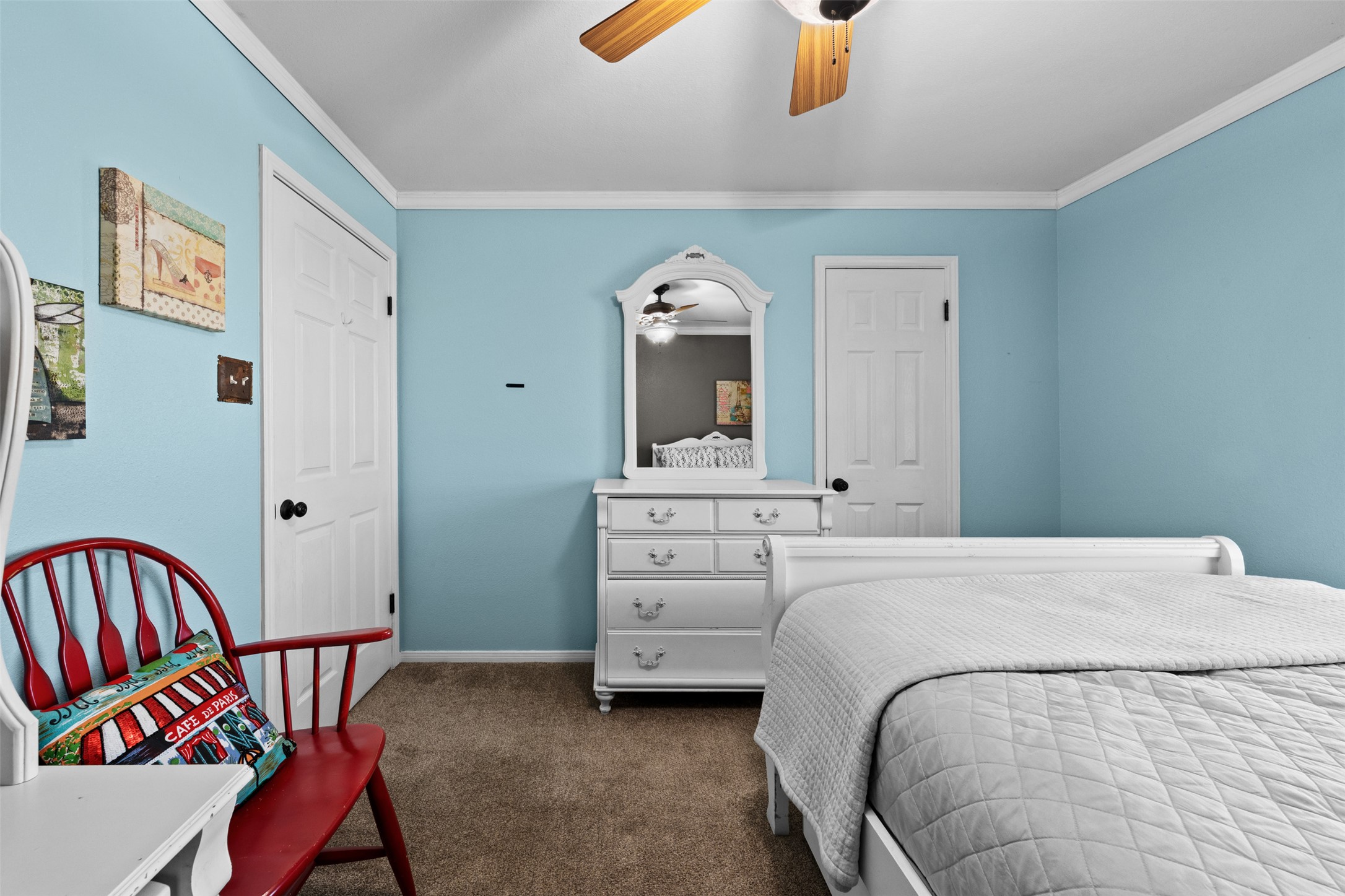 1512 Panther Loop Pflugerville, TX 78660 - Photo 10 of 40 Comfortable carpeted bedroom with a ceiling fan, offering a serene retreat.
