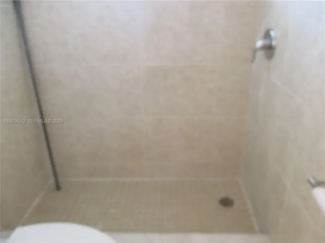 a bathroom with a shower and a toilet