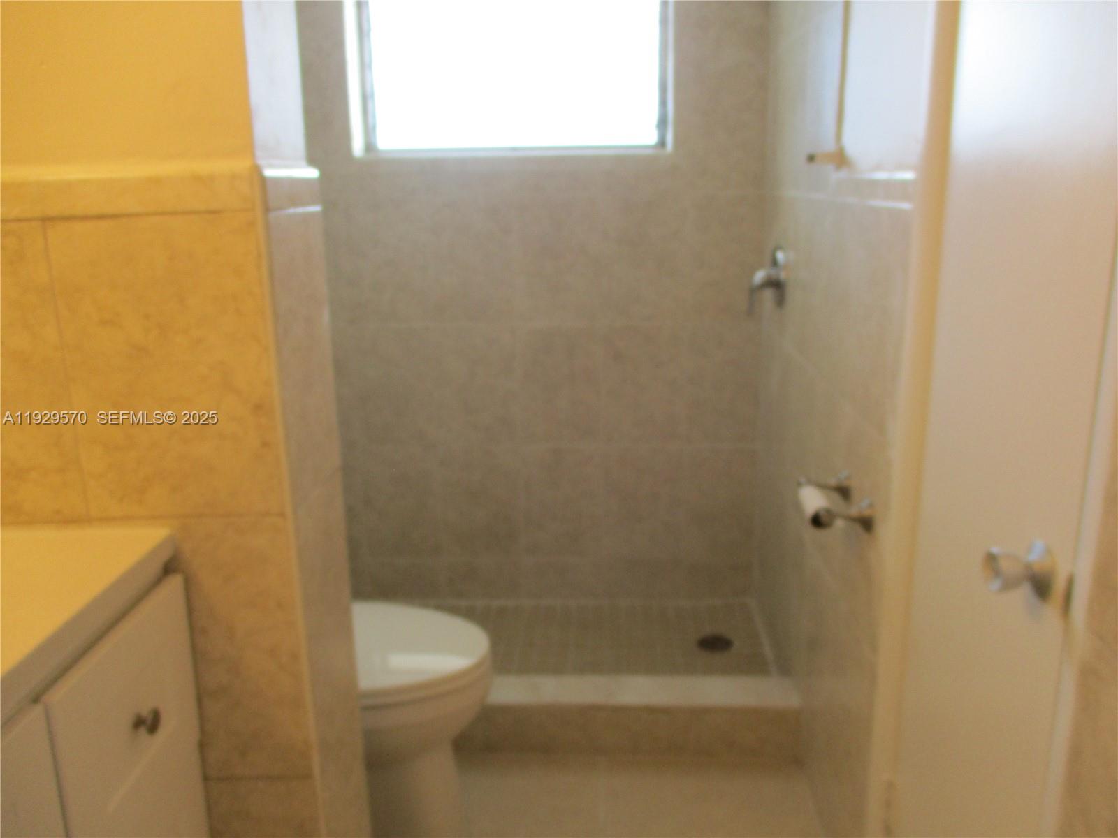 3500 Harrison Street, Unit 11 Hollywood, FL 33021 - Photo 15 of 16 a bathroom with a shower and a toilet