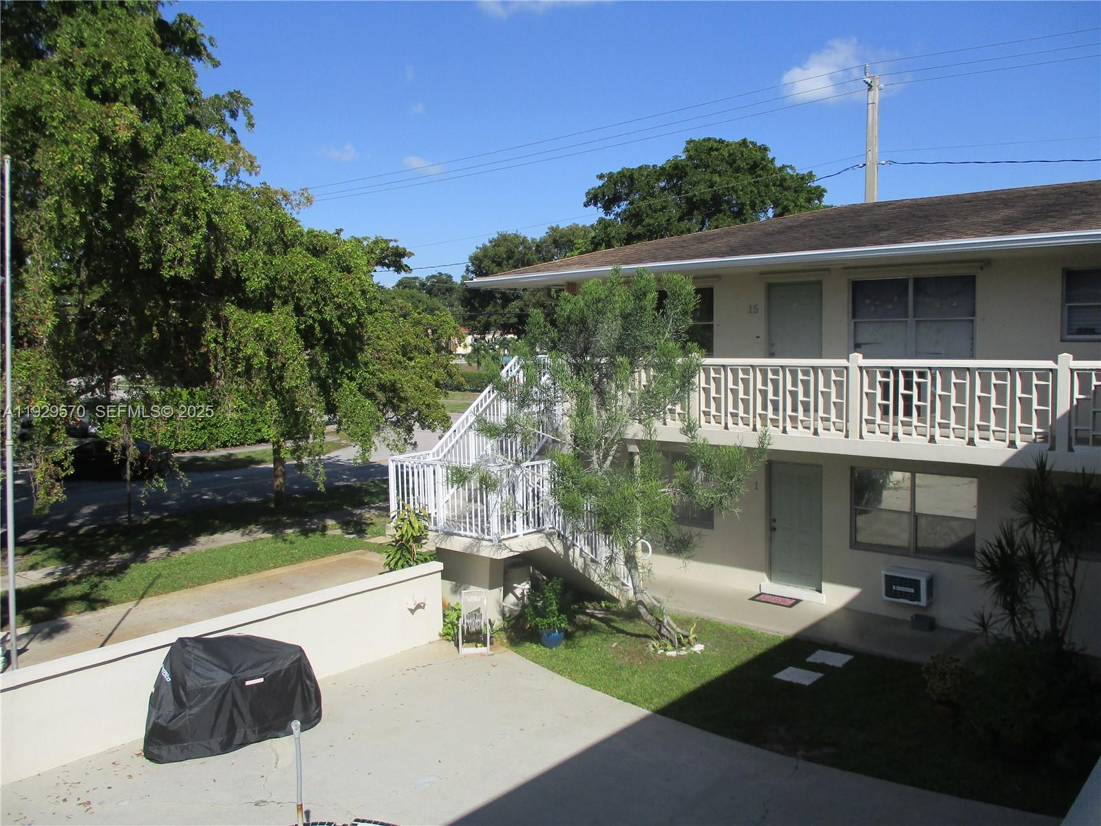 3500 Harrison Street, Unit 11 Hollywood, FL 33021 - Photo 2 of 16 a view of house with backyard outdoor seating and green space