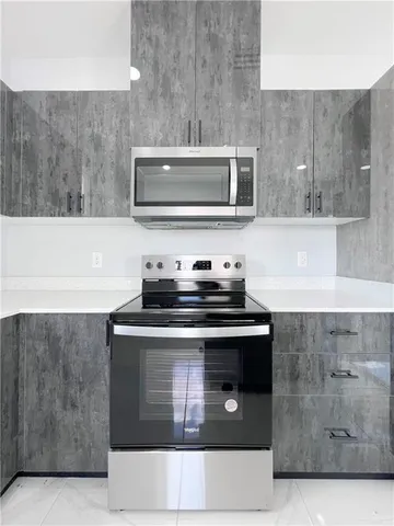 a stove top oven sitting inside of a kitchen