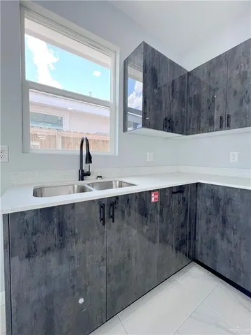 a view of a sink and a window in a room