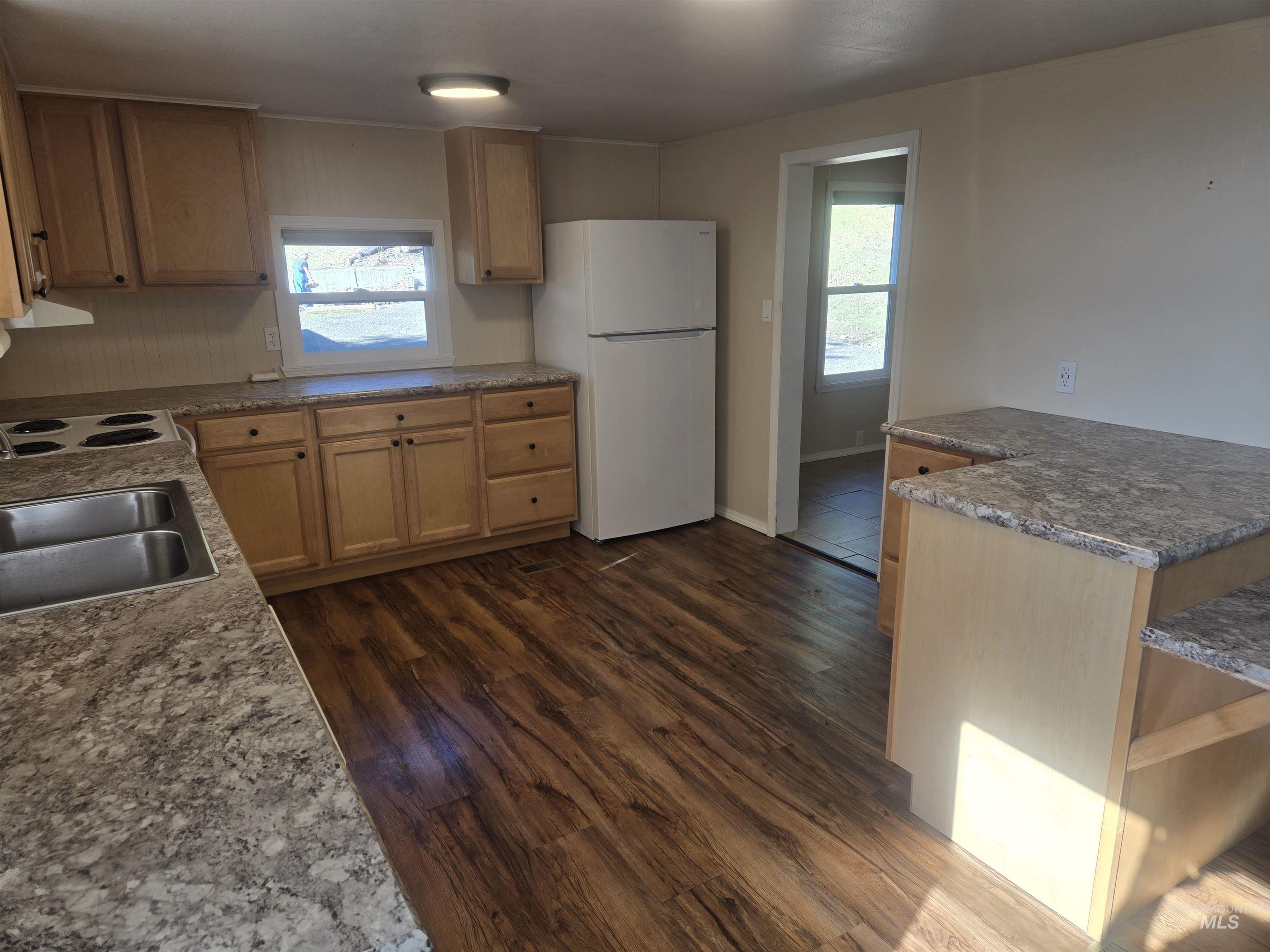 4099 Lakeview Road Orofino, ID 83544 - Photo 3 of 41 Kitchen featuring wood-finish flooring, light wood cabinetry, stone-finish countertops, and a double basin sink