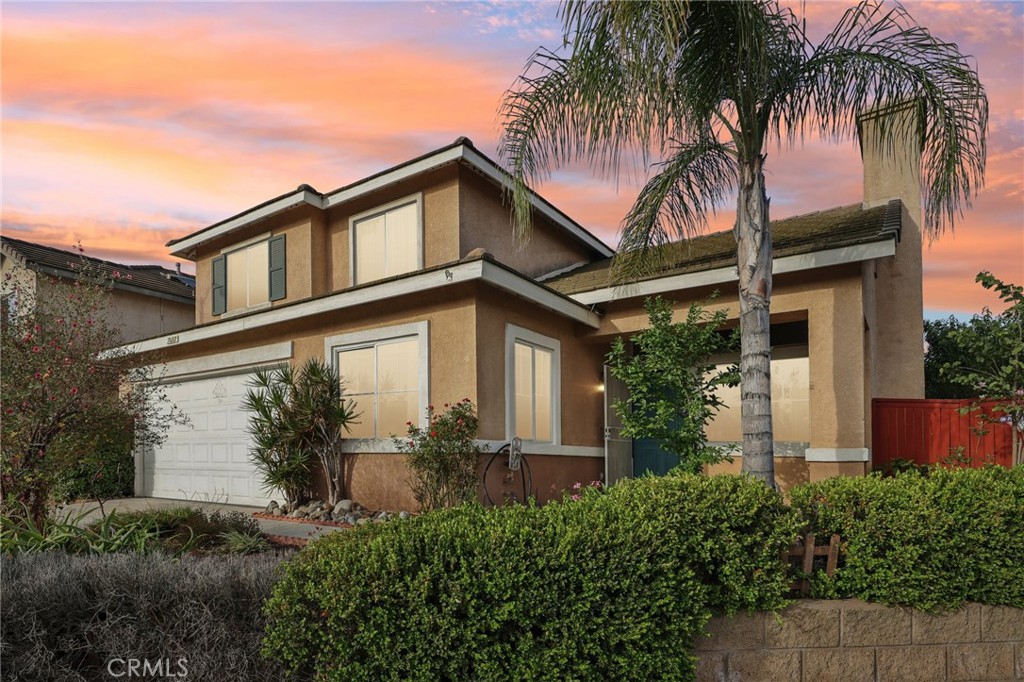 7603 Canberra Way Riverside, CA 92508 - Photo 1 of 1 front view of house with a yard and potted plants