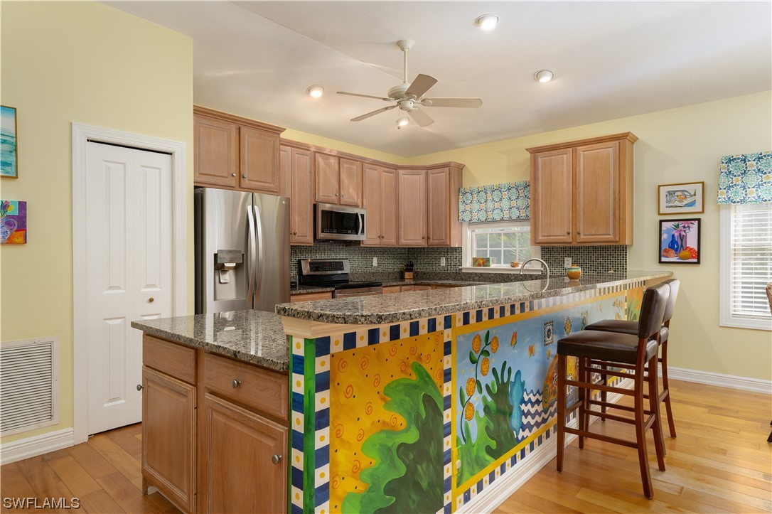 2130 Sunset Circle Sanibel, FL 33957 - Photo 11 of 36 a kitchen with stainless steel appliances granite countertop a stove refrigerator sink and microwave