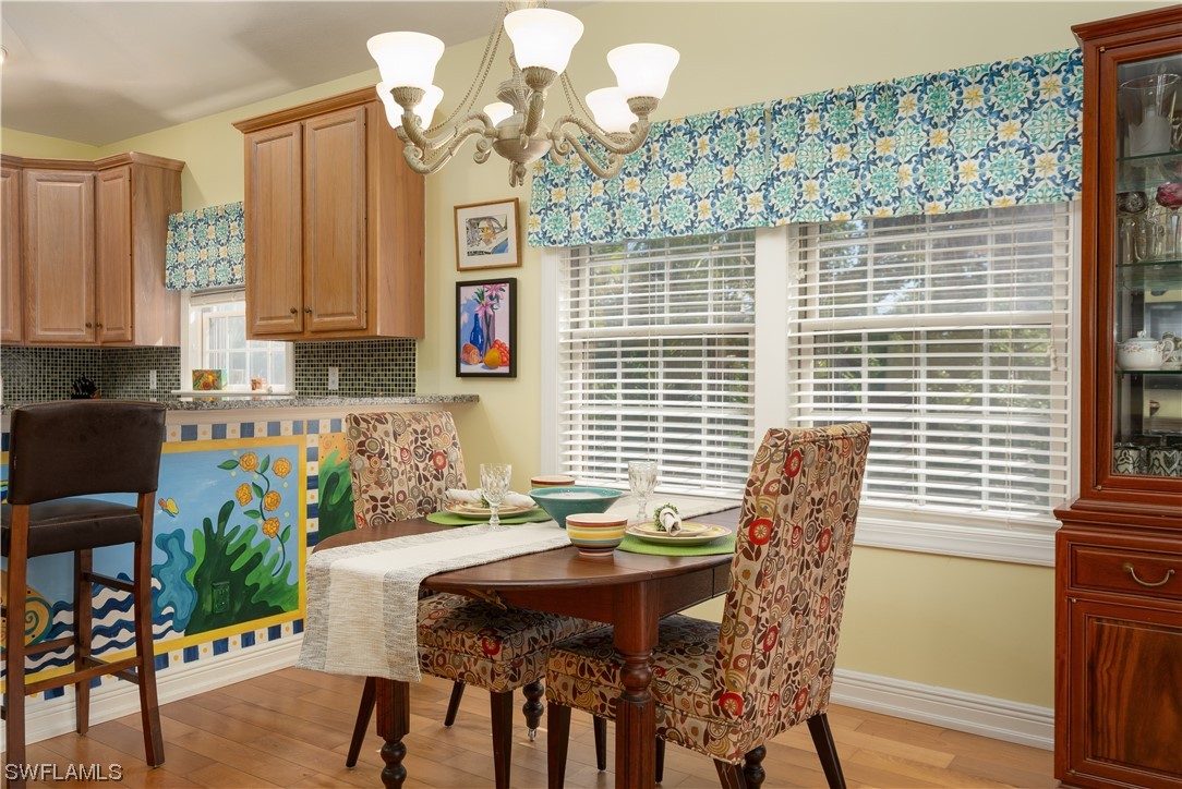 2130 Sunset Circle Sanibel, FL 33957 - Photo 12 of 36 a view of a dining room with furniture and wooden floor