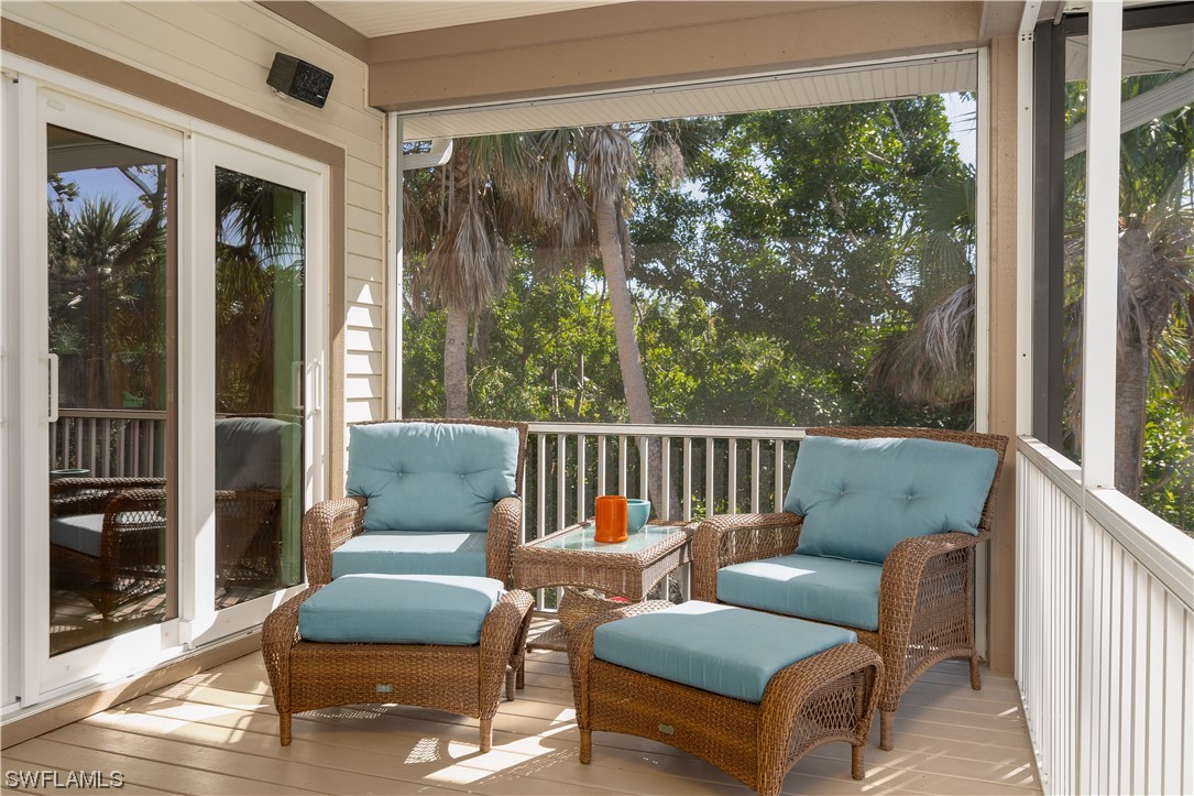2130 Sunset Circle Sanibel, FL 33957 - Photo 14 of 36 a balcony with furniture and a potted plant