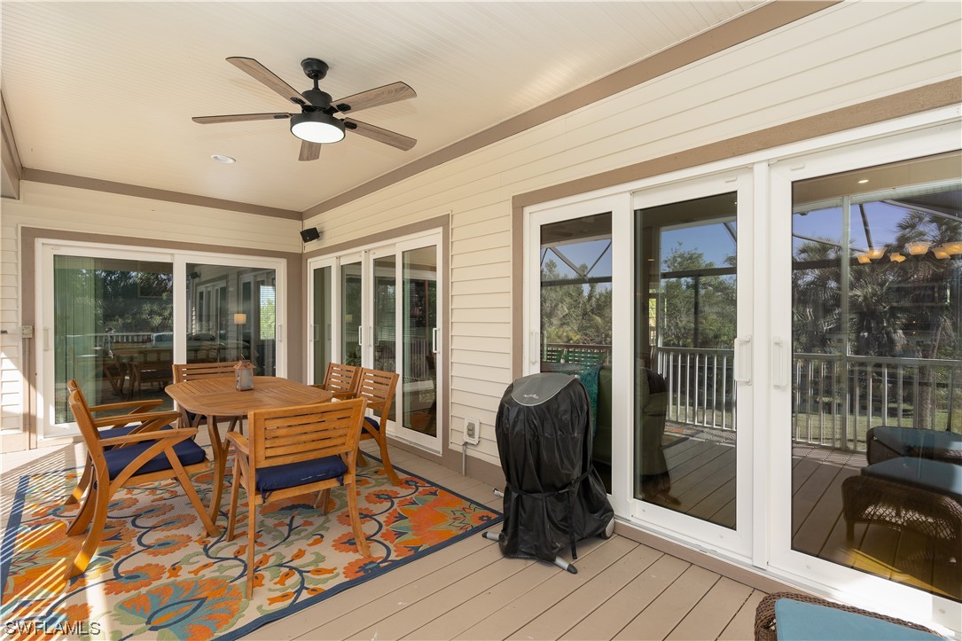 2130 Sunset Circle Sanibel, FL 33957 - Photo 15 of 36 a living room with a dining table and a floor to ceiling window