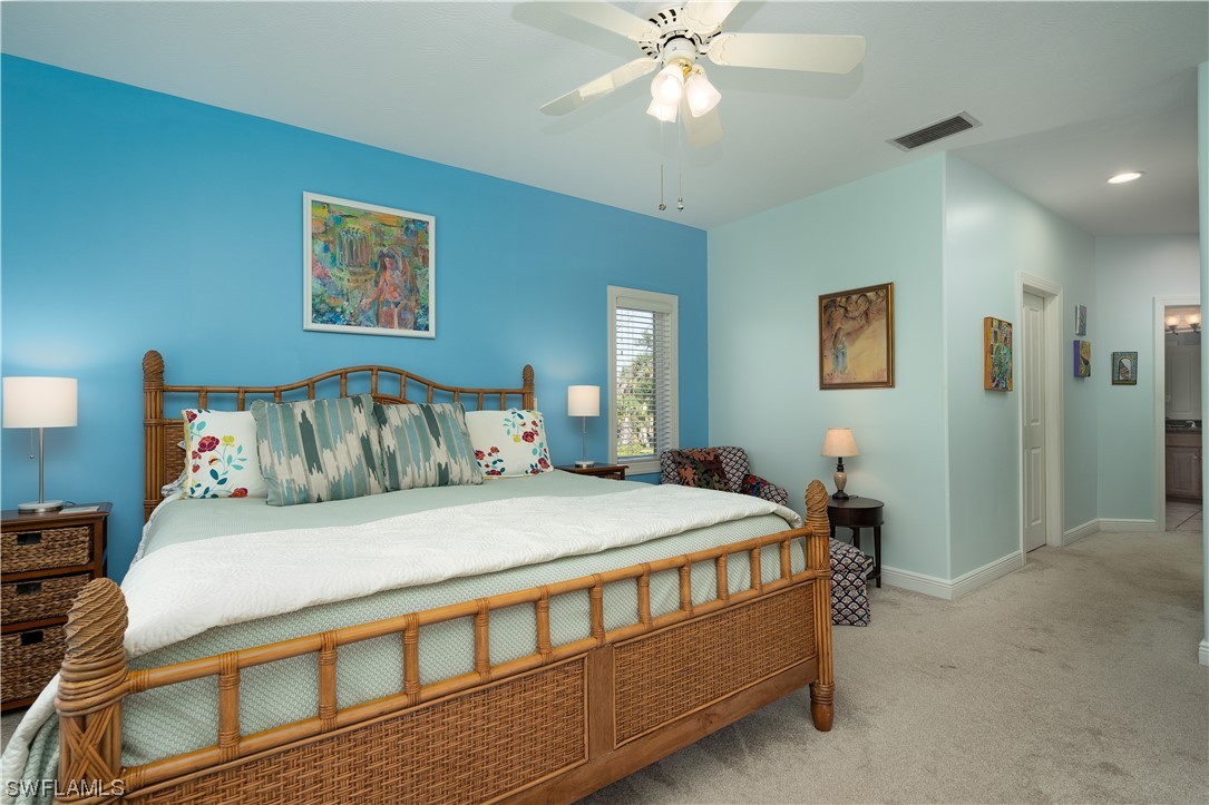 2130 Sunset Circle Sanibel, FL 33957 - Photo 17 of 36 a bedroom with a bed and a chandelier