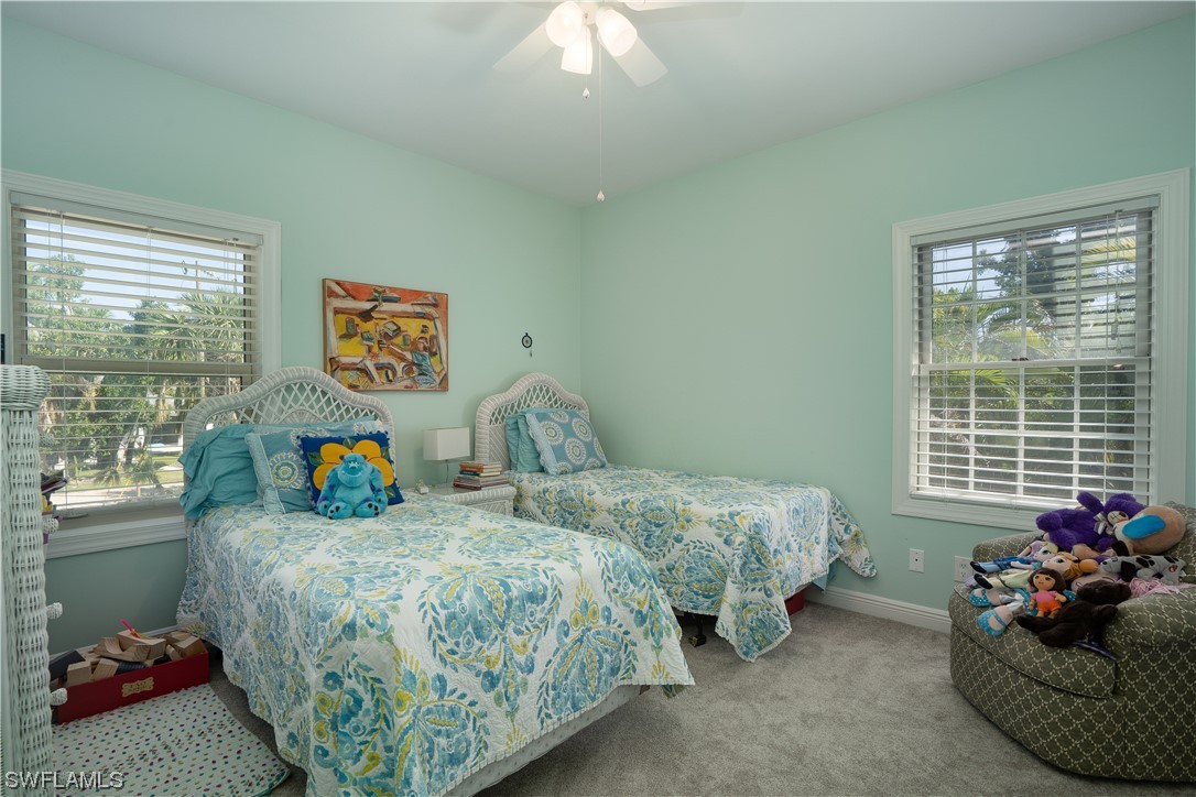 2130 Sunset Circle Sanibel, FL 33957 - Photo 21 of 36 a bedroom with two beds and potted plant