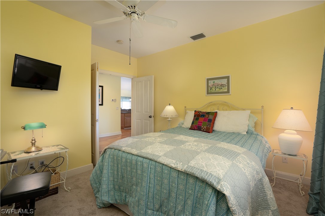 2130 Sunset Circle Sanibel, FL 33957 - Photo 22 of 36 a bedroom with a bed and flat screen tv