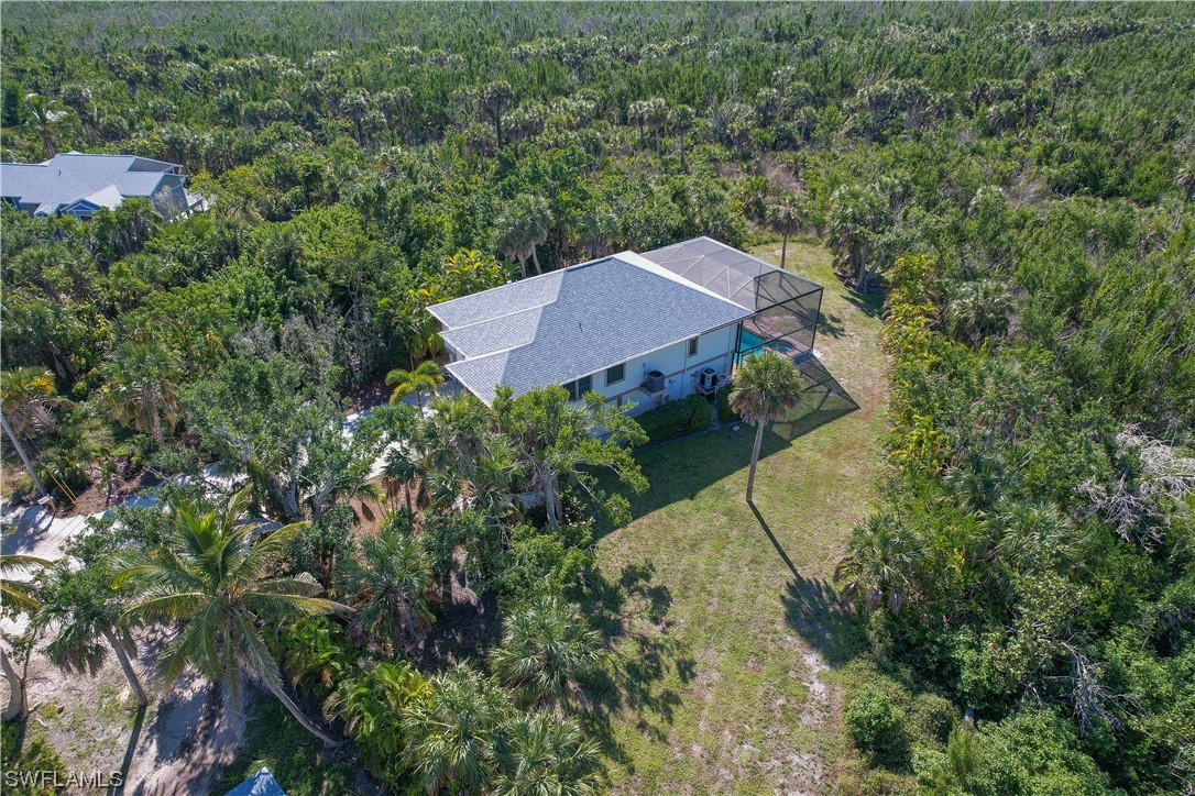 2130 Sunset Circle Sanibel, FL 33957 - Photo 25 of 36 an aerial view of a house with yard and outdoor seating