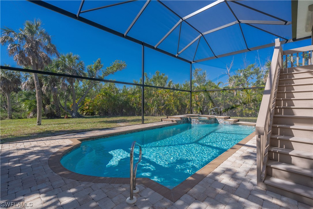 2130 Sunset Circle Sanibel, FL 33957 - Photo 3 of 36 a view of a backyard with table and chairs under an umbrella