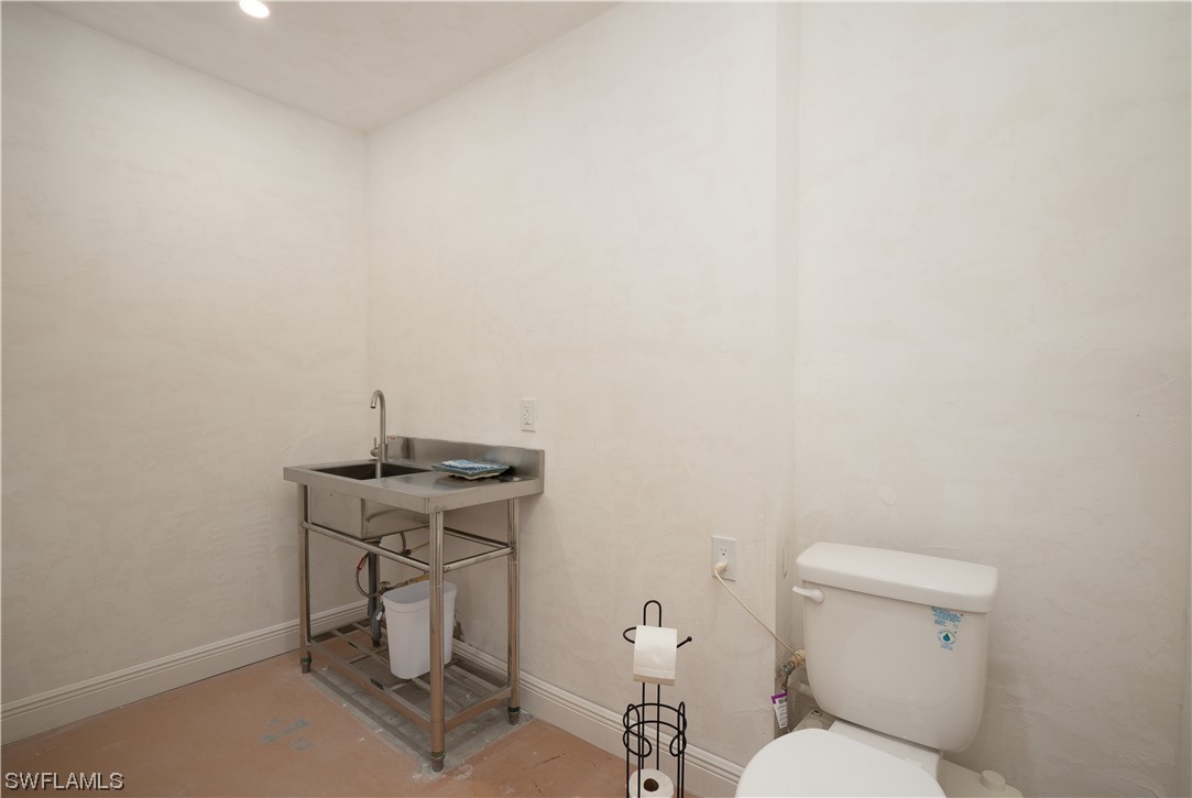 2130 Sunset Circle Sanibel, FL 33957 - Photo 35 of 36 a bathroom with a toilet a sink and a mirror