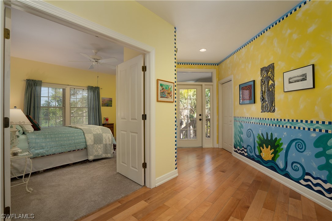 2130 Sunset Circle Sanibel, FL 33957 - Photo 5 of 36 a bedroom with a bed and a mirror