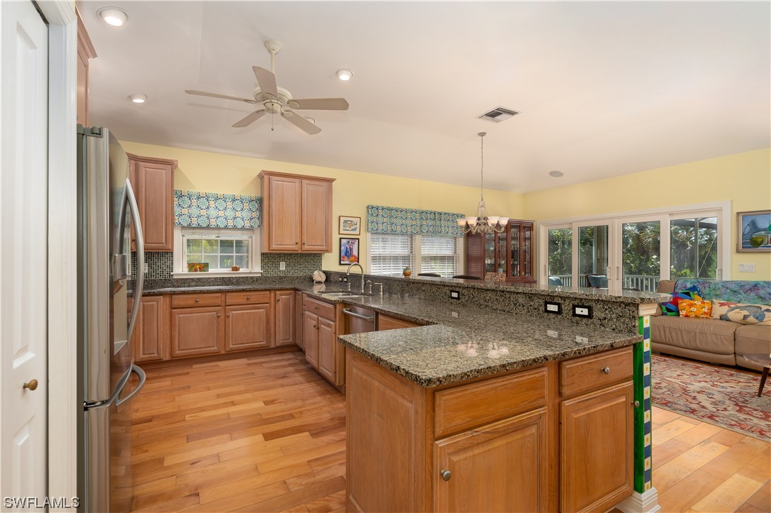 2130 Sunset Circle Sanibel, FL 33957 - Photo 8 of 36 a kitchen with a counter top space a sink appliances and cabinets