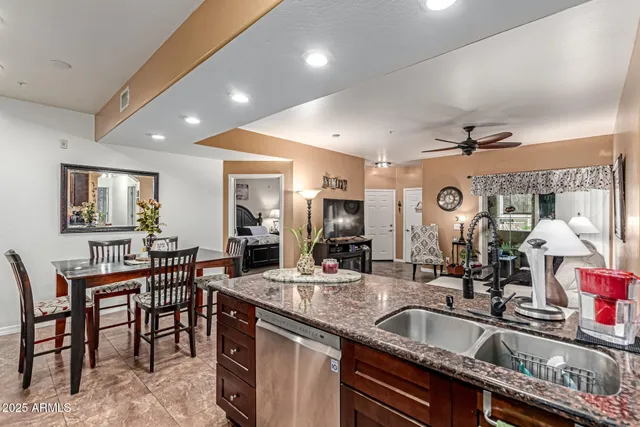 a kitchen with granite countertop a sink and cabinets
