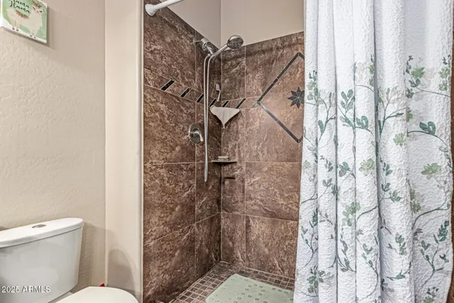 a bathroom with a toilet and shower