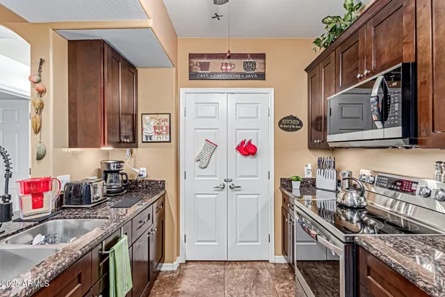 a kitchen with stainless steel appliances granite countertop a stove and cabinets
