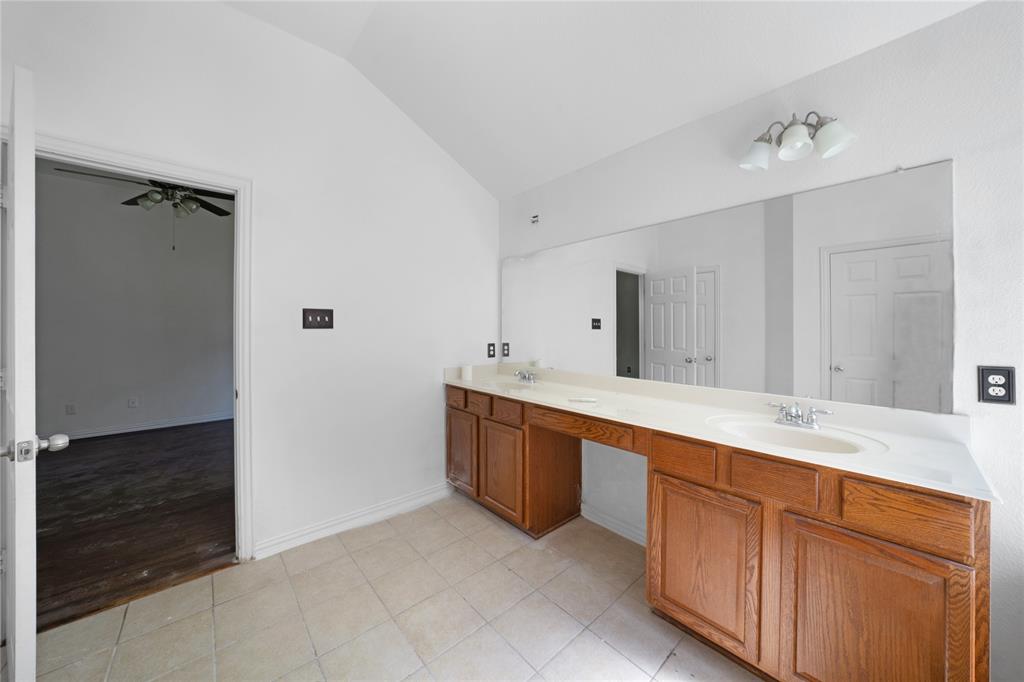 317 Parakeet Drive Little Elm, TX 75068 - Photo 15 of 17 a spacious bathroom with double vanity and a mirror