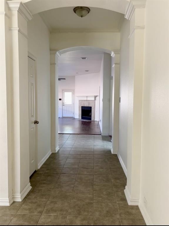 317 Parakeet Drive Little Elm, TX 75068 - Photo 4 of 17 a view of a hallway with wooden floor and a fireplace