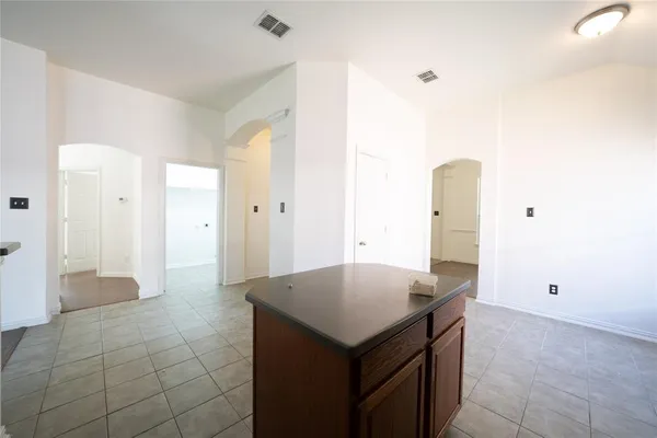 a kitchen with a cabinet a refrigerator and a sink