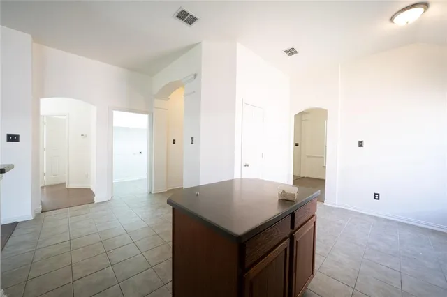 a kitchen with a cabinet a refrigerator and a sink