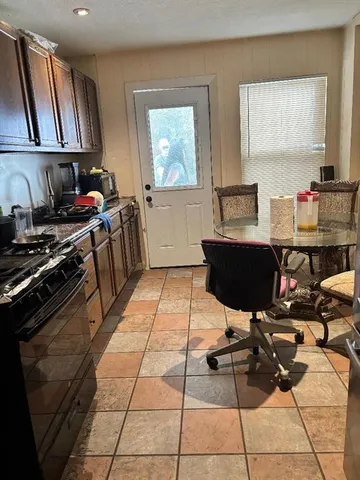 a kitchen with a sink and a stove top oven