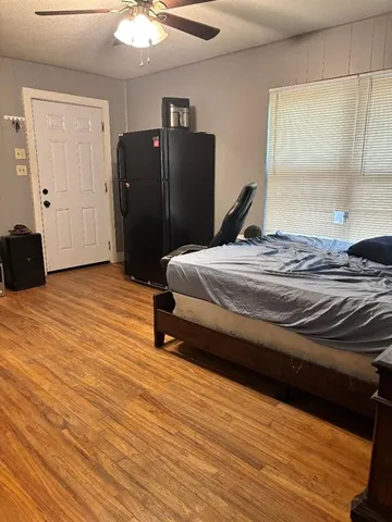 a bedroom with a bed and a dresser