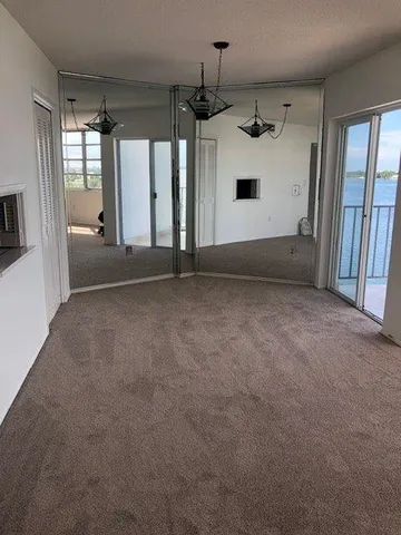 an empty room with windows and entryway