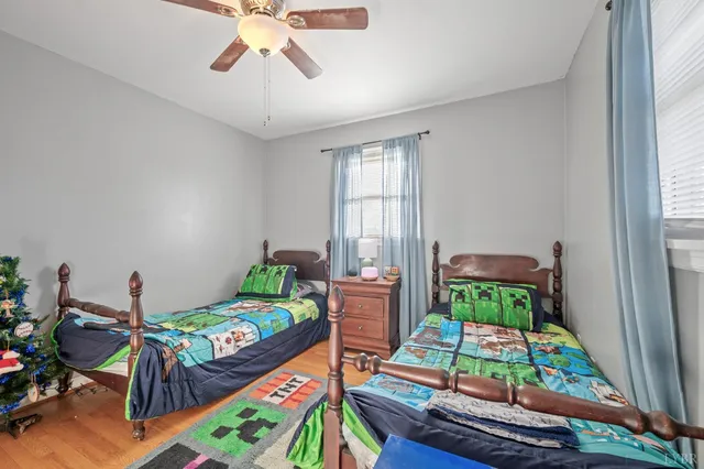 a bedroom with two beds and a chandelier