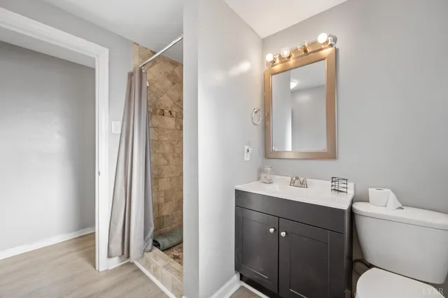 a bathroom with a toilet a sink and a mirror