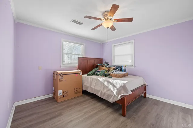 a bedroom with a bed and a ceiling fan