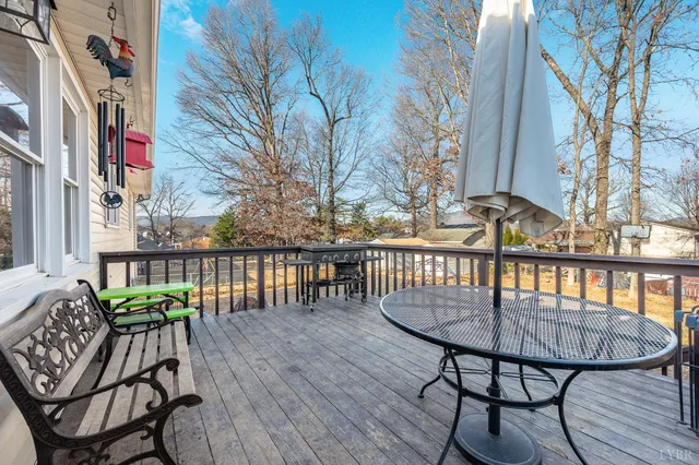 a view of balcony with wooden floor and outdoor seating