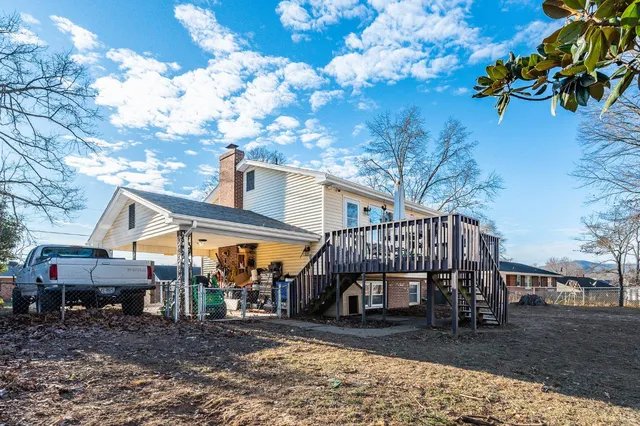 a view of a small house with a tree in the yard