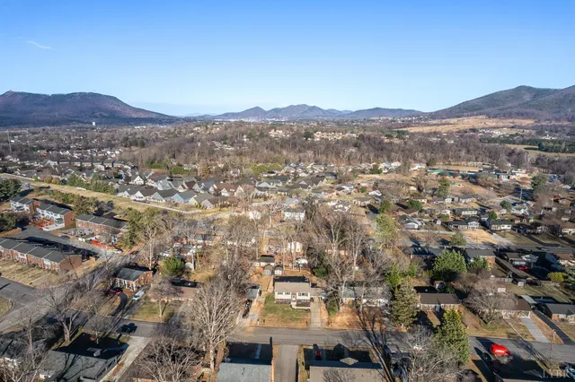an aerial view of residential houses and large trees