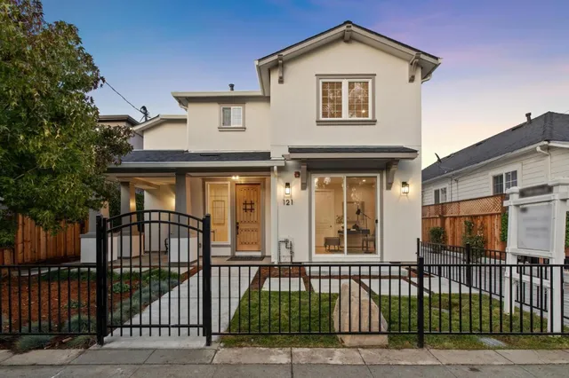 a view of a brick house with large windows