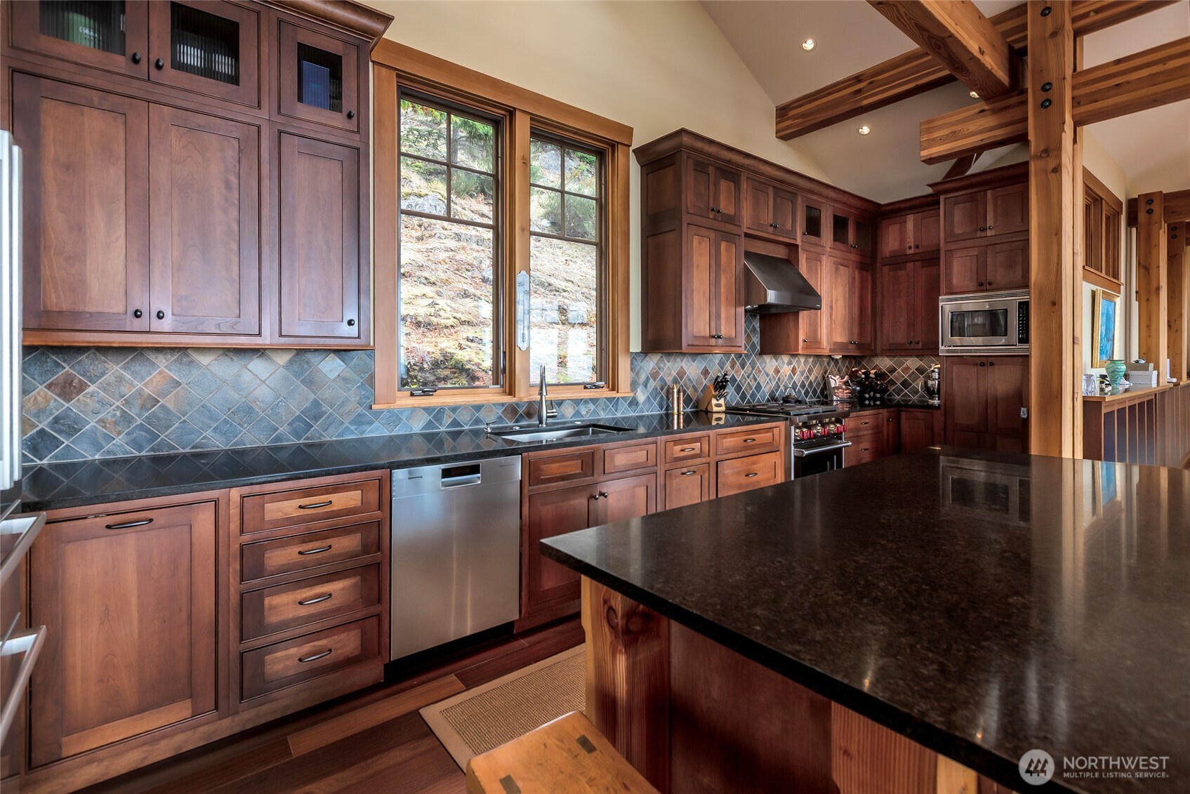 260 West Side Road Friday Harbor, WA 98250 - Photo 10 of 40 a kitchen with stainless steel appliances granite countertop a sink a stove and a wooden cabinets