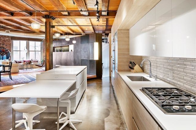 a kitchen with a sink a stove and chairs
