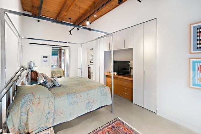 a bedroom with a bed and a walk in closet