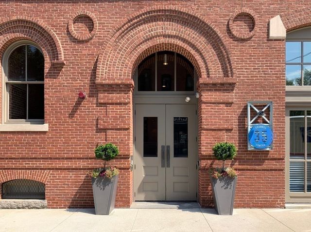 a front view of a house with potted plants