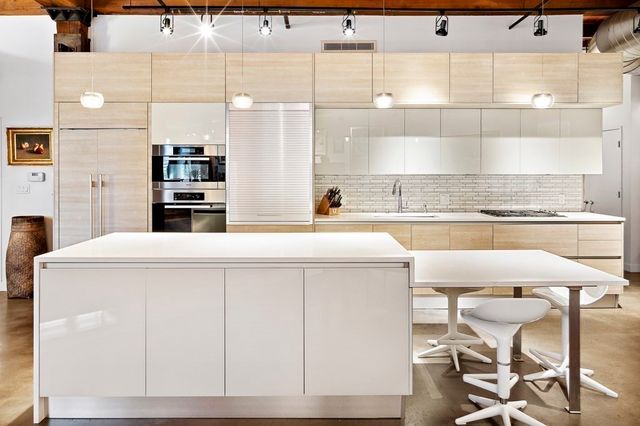 a kitchen with a table chairs stove and cabinets