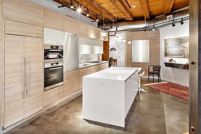 a kitchen with a sink appliances and cabinets