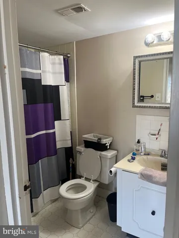 a white toilet sitting next to a bathroom sink