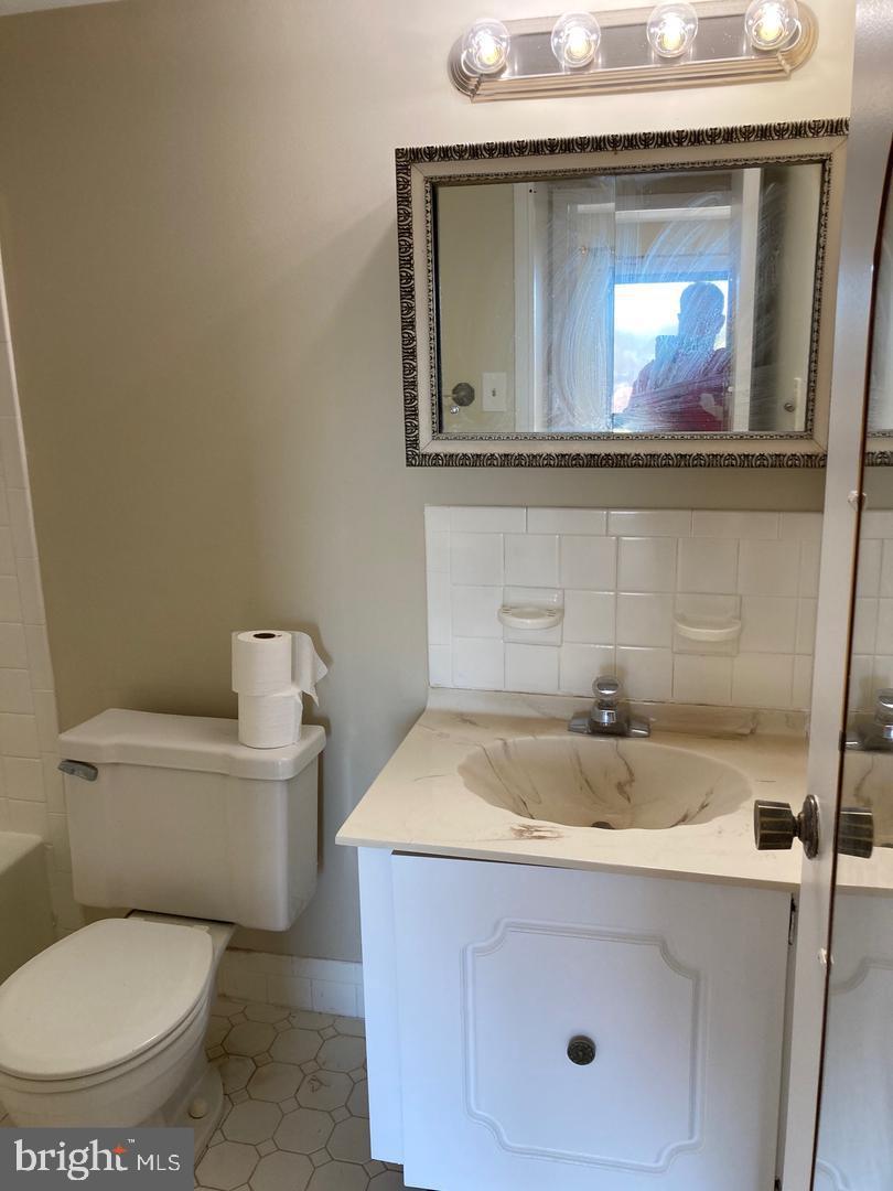 7600 Roosevelt Boulevard, Unit 806 Philadelphia, PA 19152 - Photo 5 of 16 a bathroom with a toilet sink and mirror