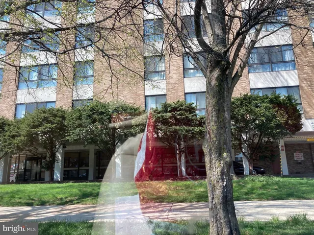a aerial view of a house with swimming pool and trees