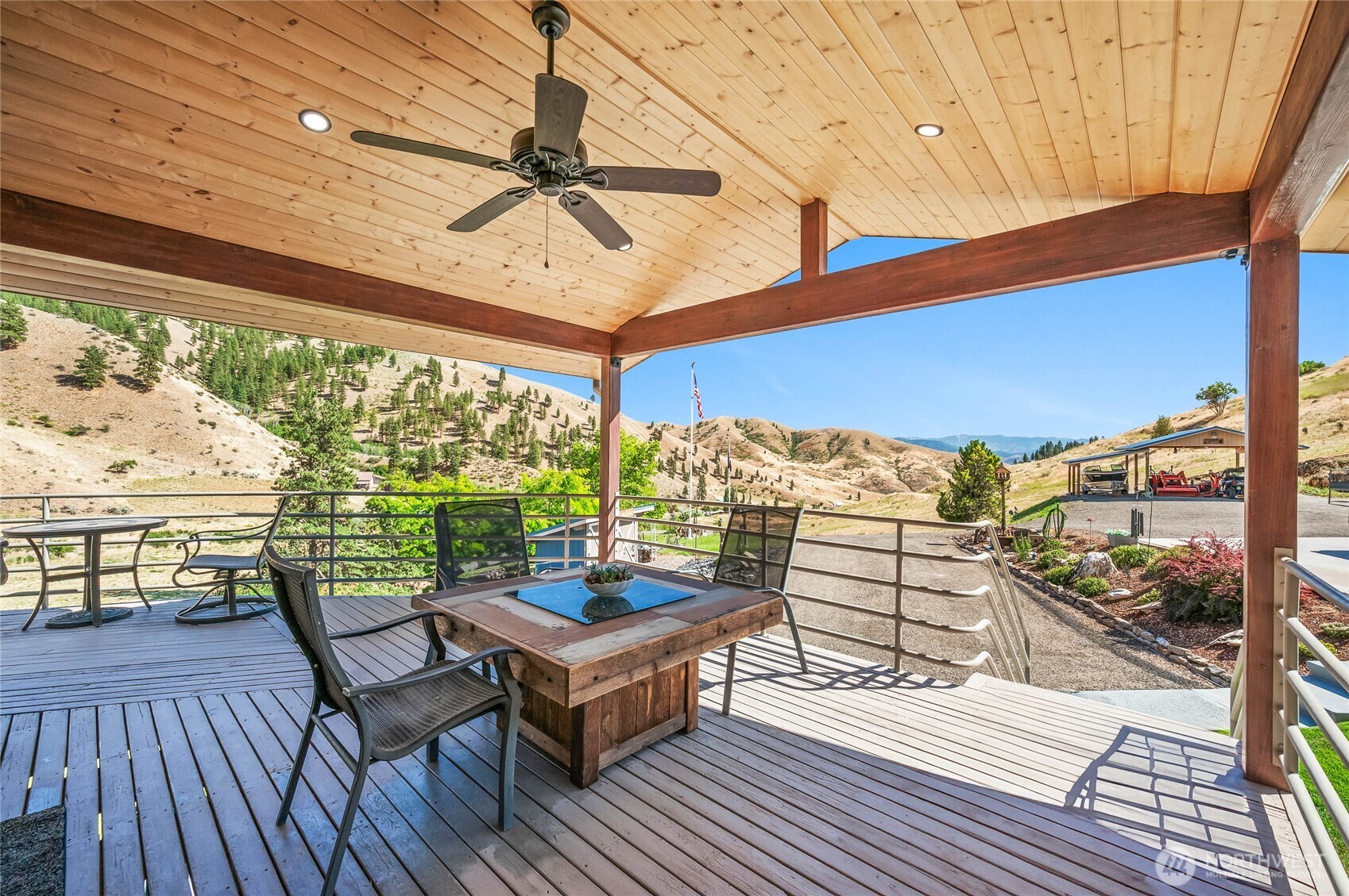 8770 Nahahum Canyon Road Cashmere, WA 98815 - Photo 5 of 36 a view of a balcony with furniture and wooden floor