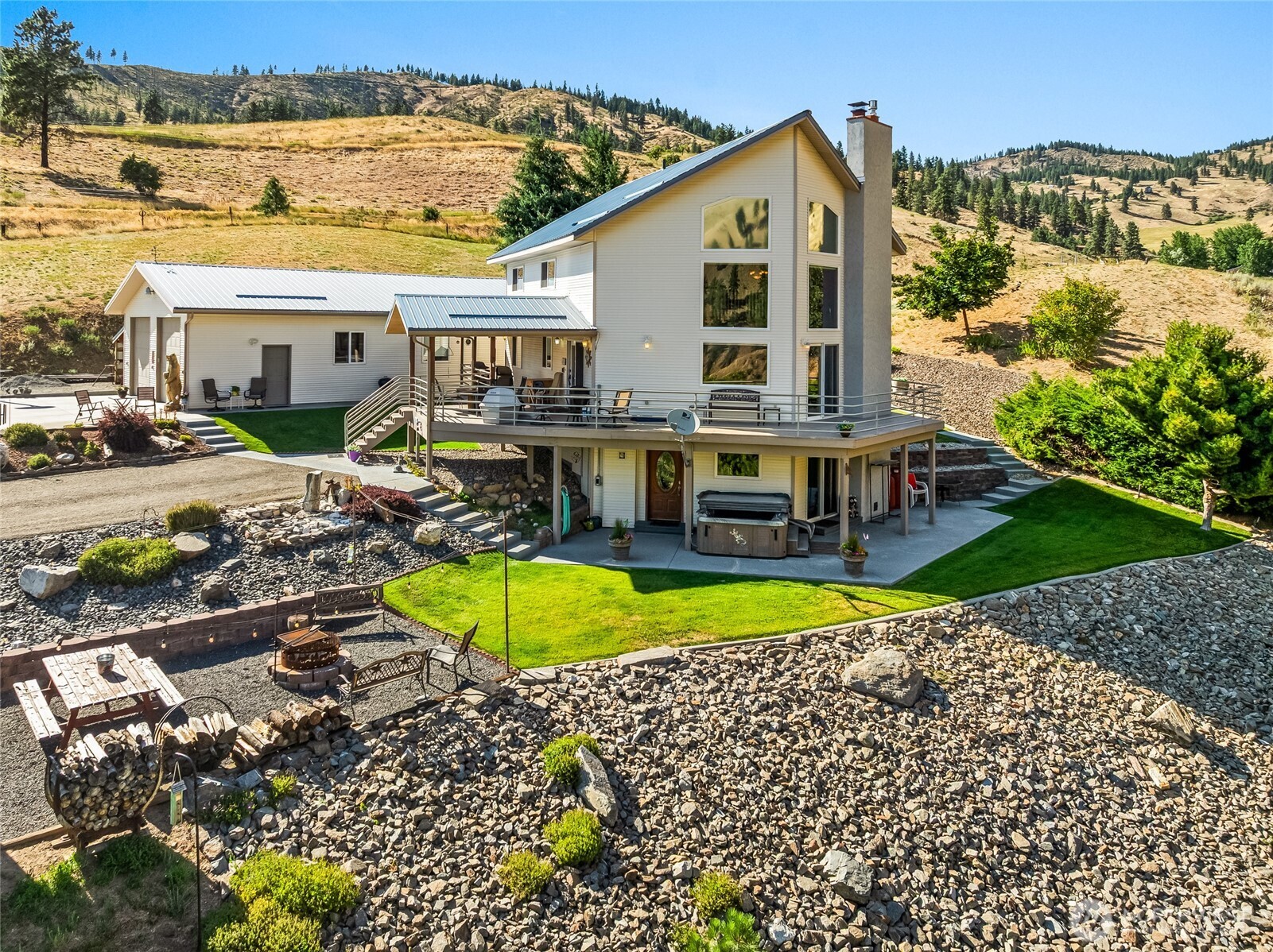 8770 Nahahum Canyon Road Cashmere, WA 98815 - Photo 6 of 36 a view of a house with a swimming pool and a yard